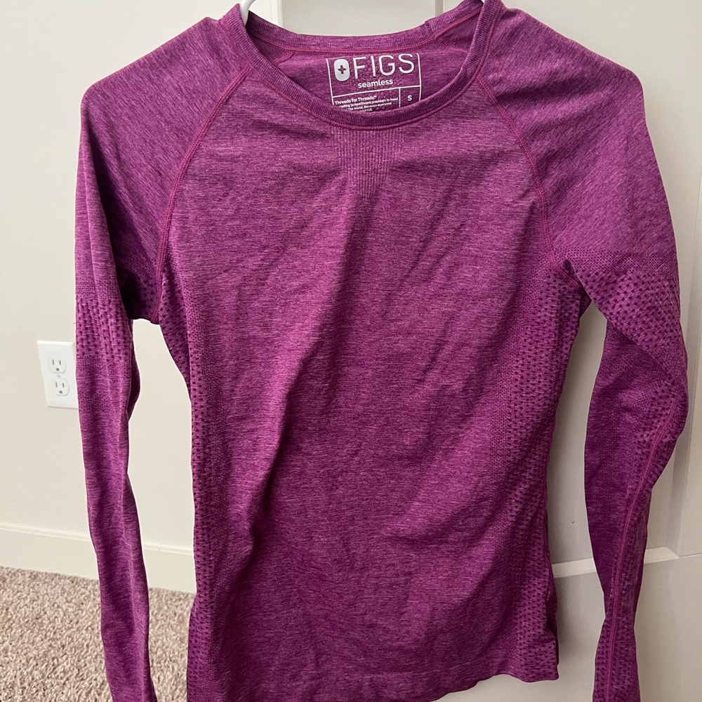 Size small figs under scrub long sleeve.